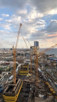 an aerial view of construction cranes at a construction site