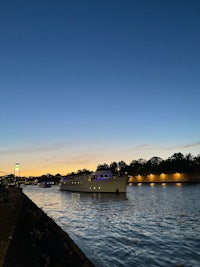 a boat on a river at dusk